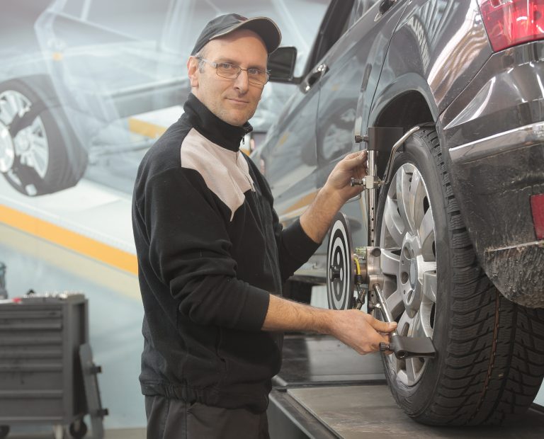 Man-in-black-jacket-standing-beside-black-car-3806288-768x620.jpg